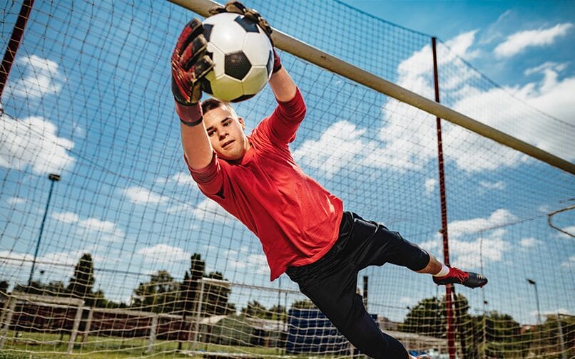Image of a boy catching a soccer ball