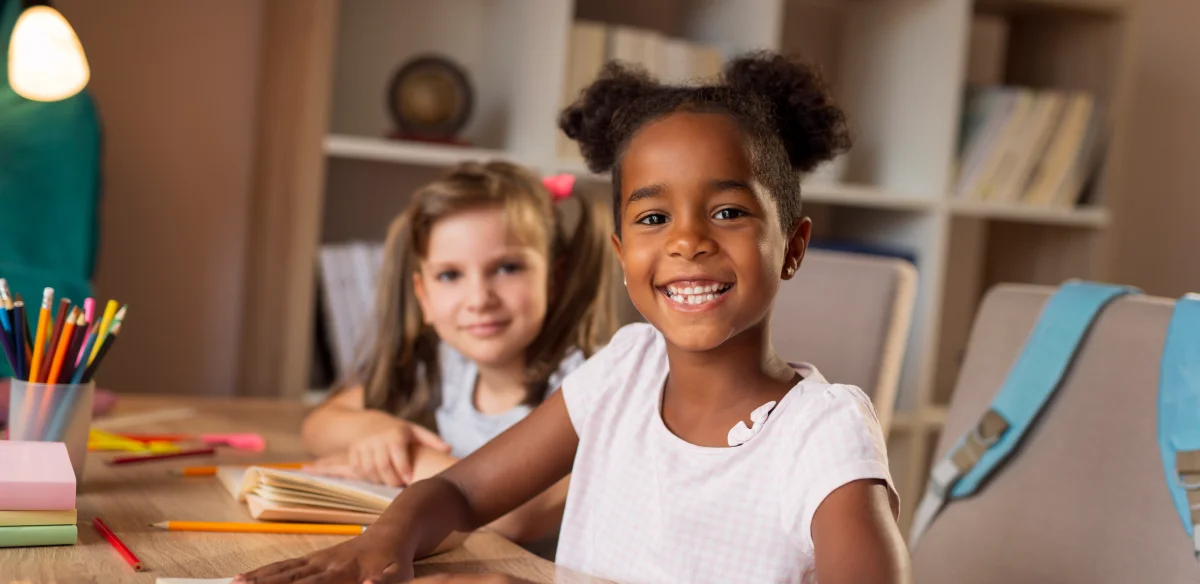two little girls smiling at the camera